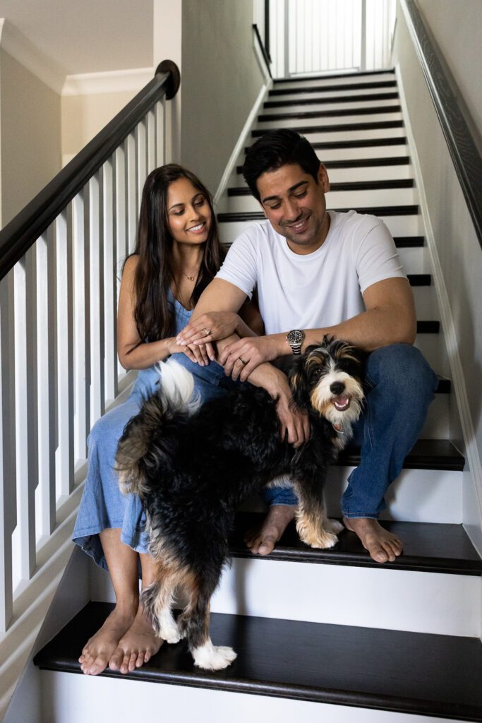 married couple with new puppy sitting on stairs in Smyrna