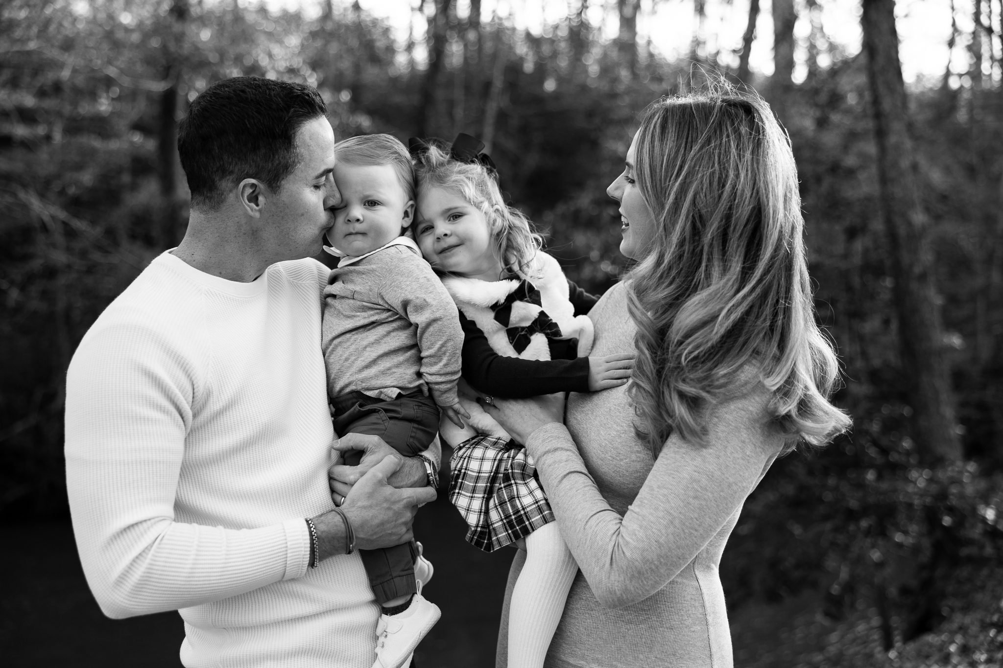 black and white candid family moment with parents and children during Roswell family session
