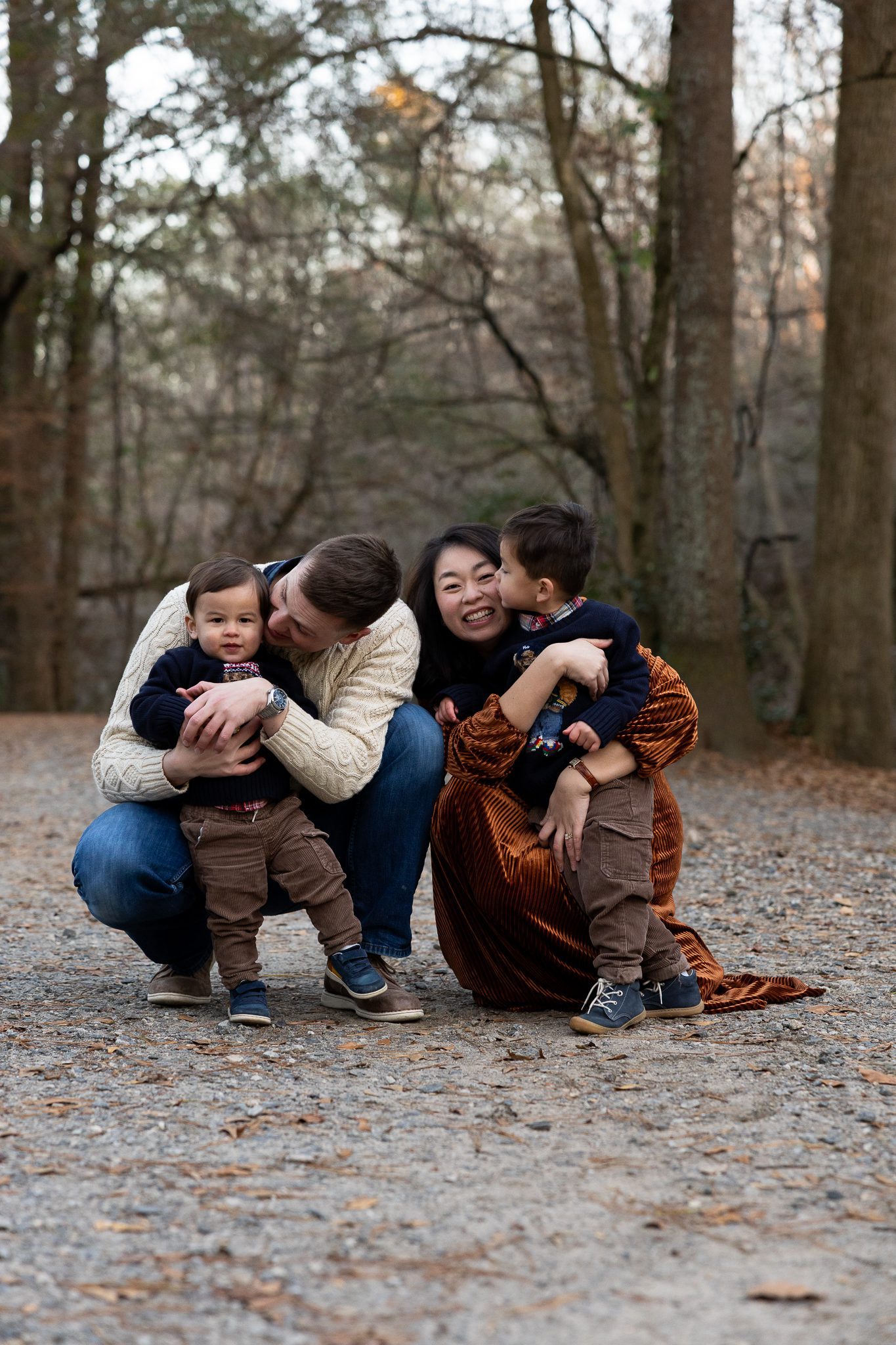 family hugging and laughing together during fall family session in Roswell Georgia